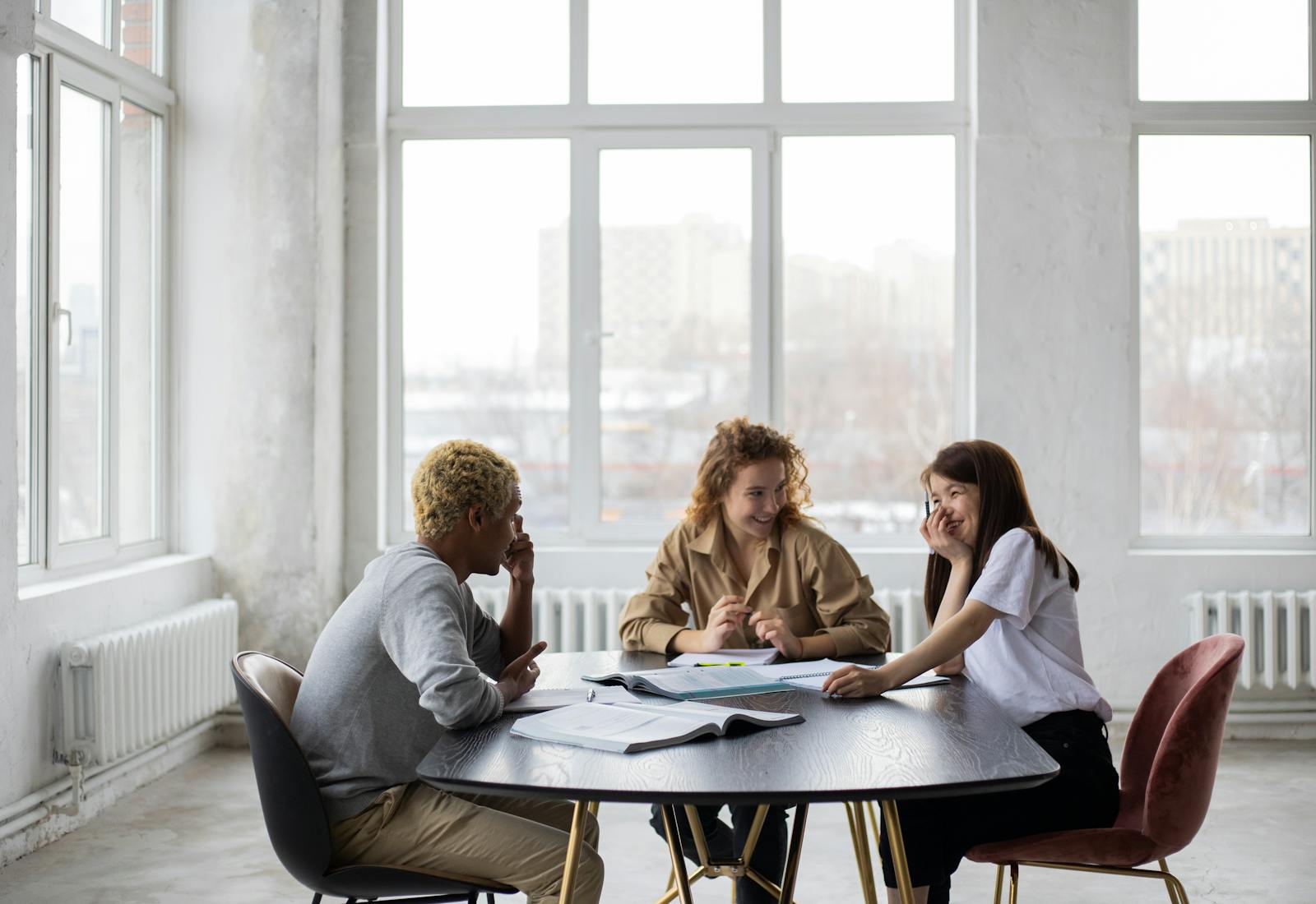 Students from different backgrounds studying together around a table.